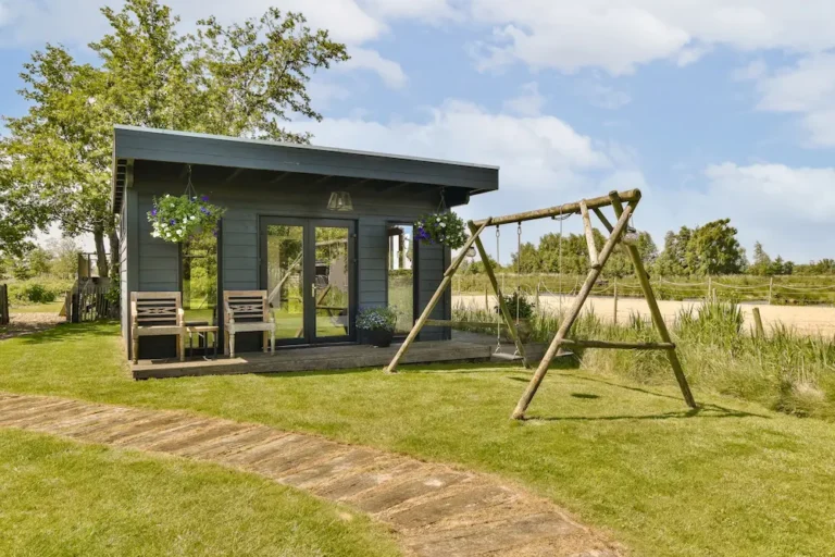 a-small-shed-with-a-swing-on-the-lawn-2025-02-09-22-36-09-utc